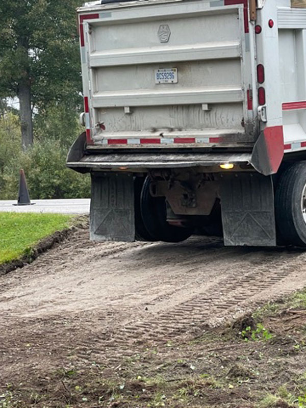 Back of dump truck in cleared driveway